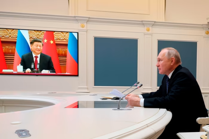 Vladimir Putin and Xi Jinping speak via video link in December. Several Chinese officials have in private striven to distance Beijing from Moscow on the issue of Ukraine