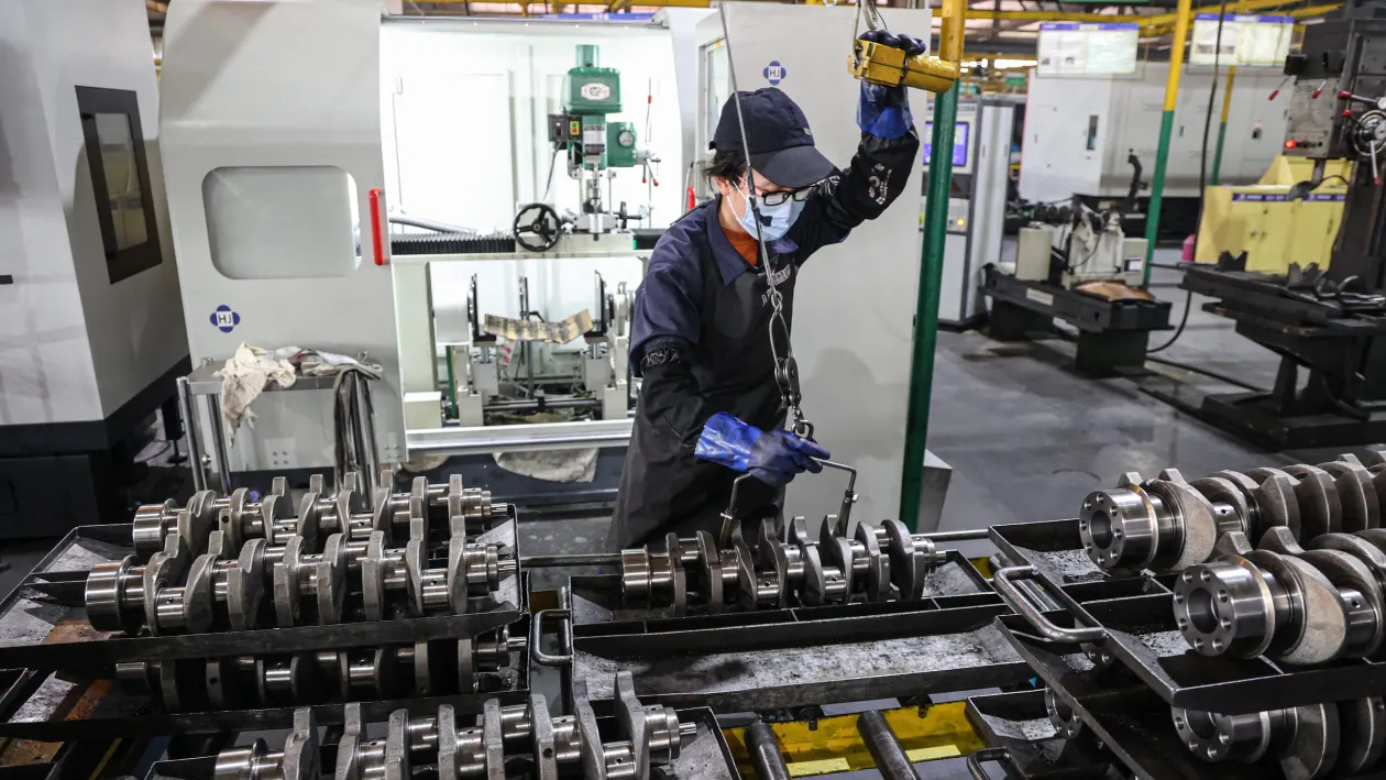 An employee works on a vehicle crankshaft production line at a factory which produces engine parts in Binzhou, in eastern China's Shandong province on March 14, 2025. (Photo by AFP) / China OUT (Photo by STR/AFP via Getty Images)          